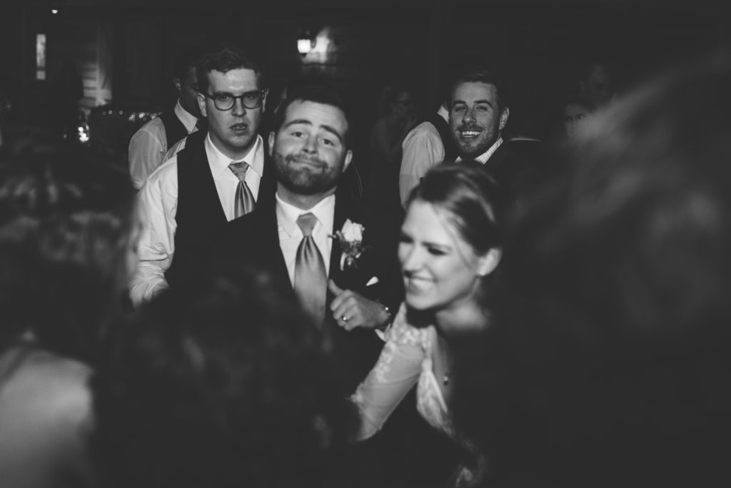 Groom and New Bride hitting the dance floor in a black and white photo