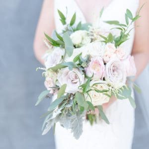 Close up shot of a bridal bouquet featuring lush colors of green pink blush and ivory on a wedding day in Nashville 