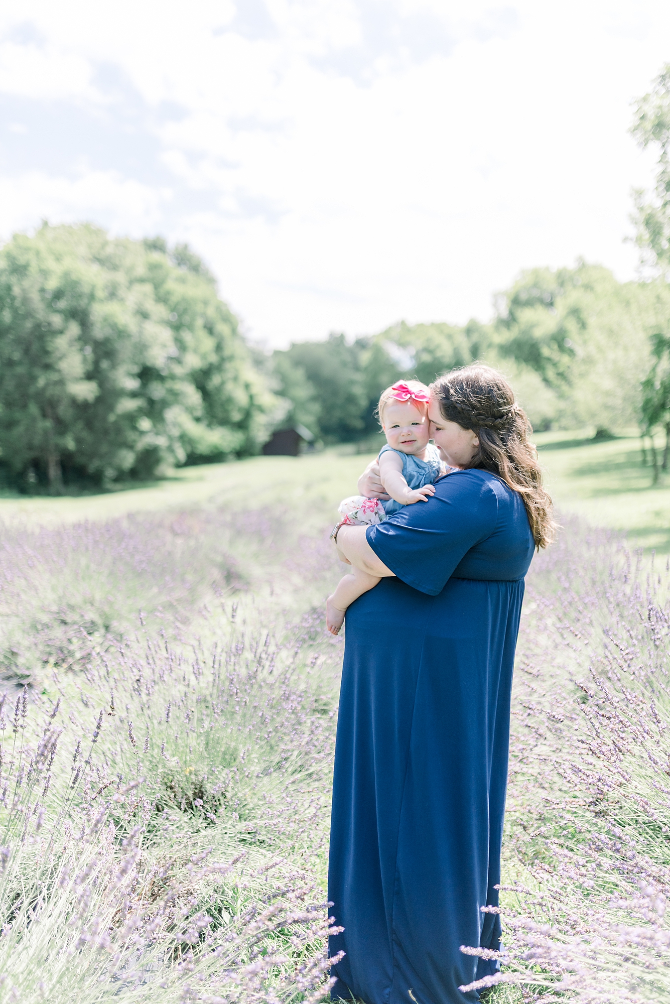 Mom holding baby girl in a lavender field in Nashville TN for girls One Year old Portrait Session