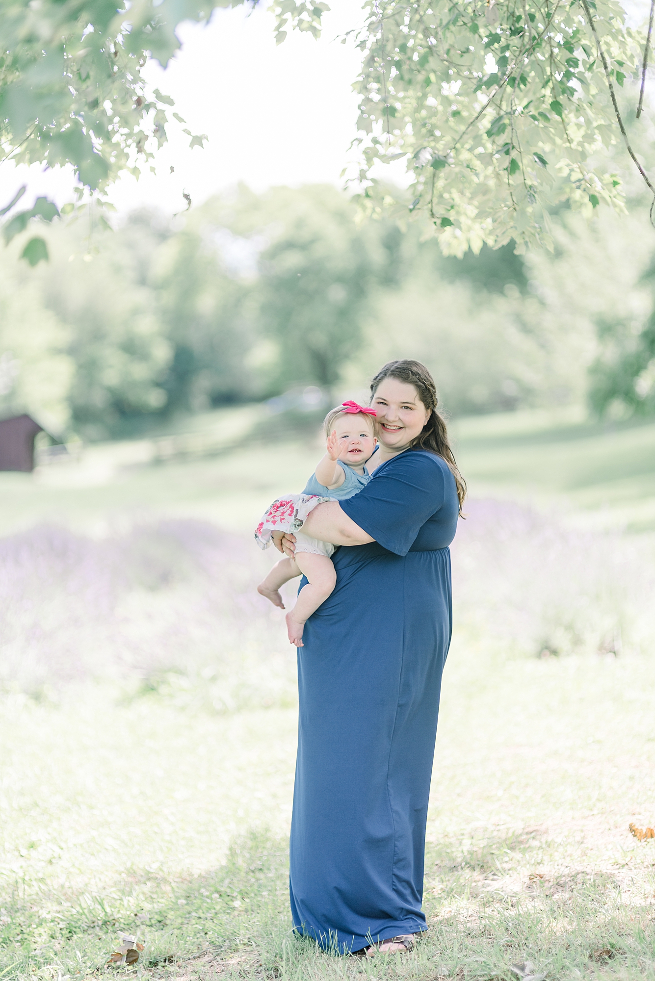 Mom holding baby girl in a lavender field in Nashville TN for girls One Year old Portrait Session
