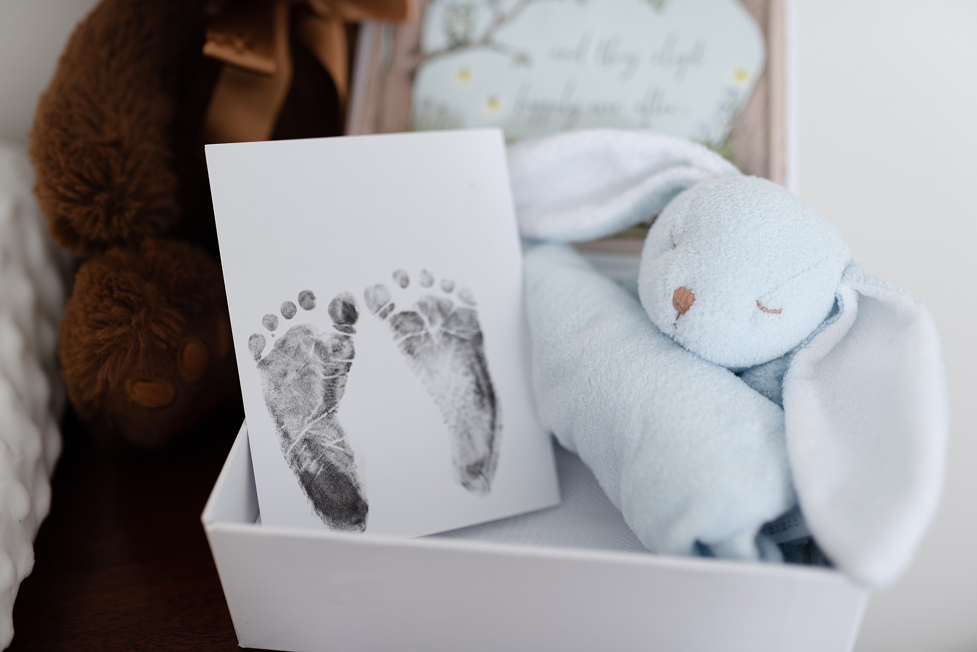 Newborn Nursery Decor Footprints and a baby bunny on top of a changing table nursery details