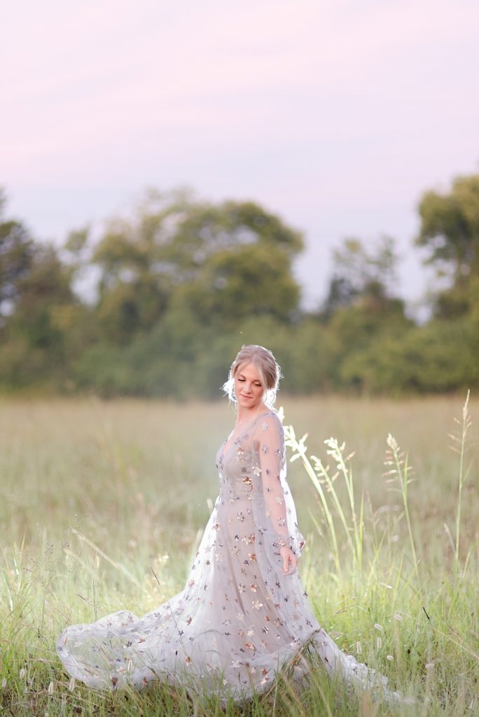 Caucasian woman wearing the stardust dress in the early morning of twilight before sunrise for a portrait session in Nashville by Dolly DeLong Photography