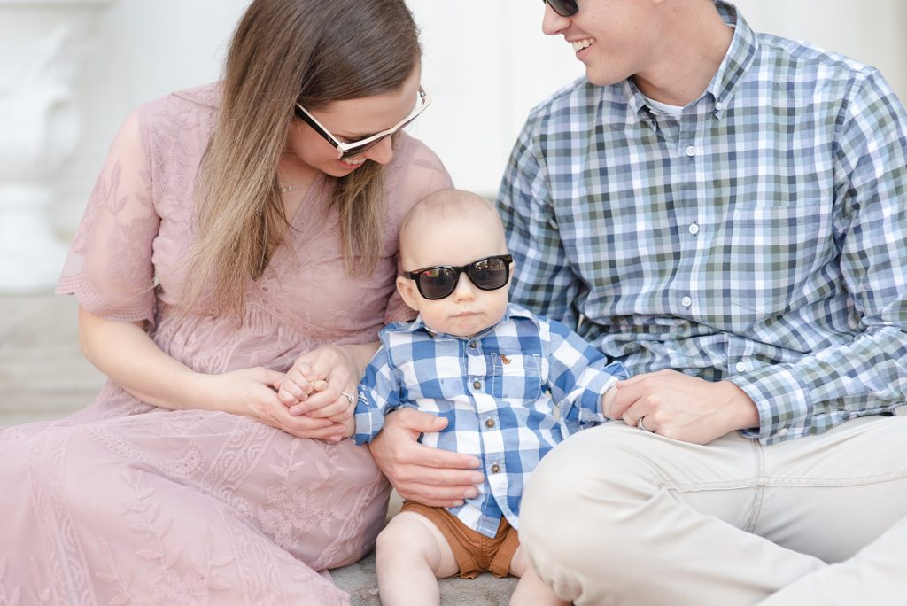baby boy is wearing sunglasses for family portraits
