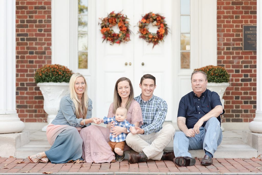 Father, Mother, Baby Boy and Two Grandparents are smiling at the camera for family portraits in Nashville