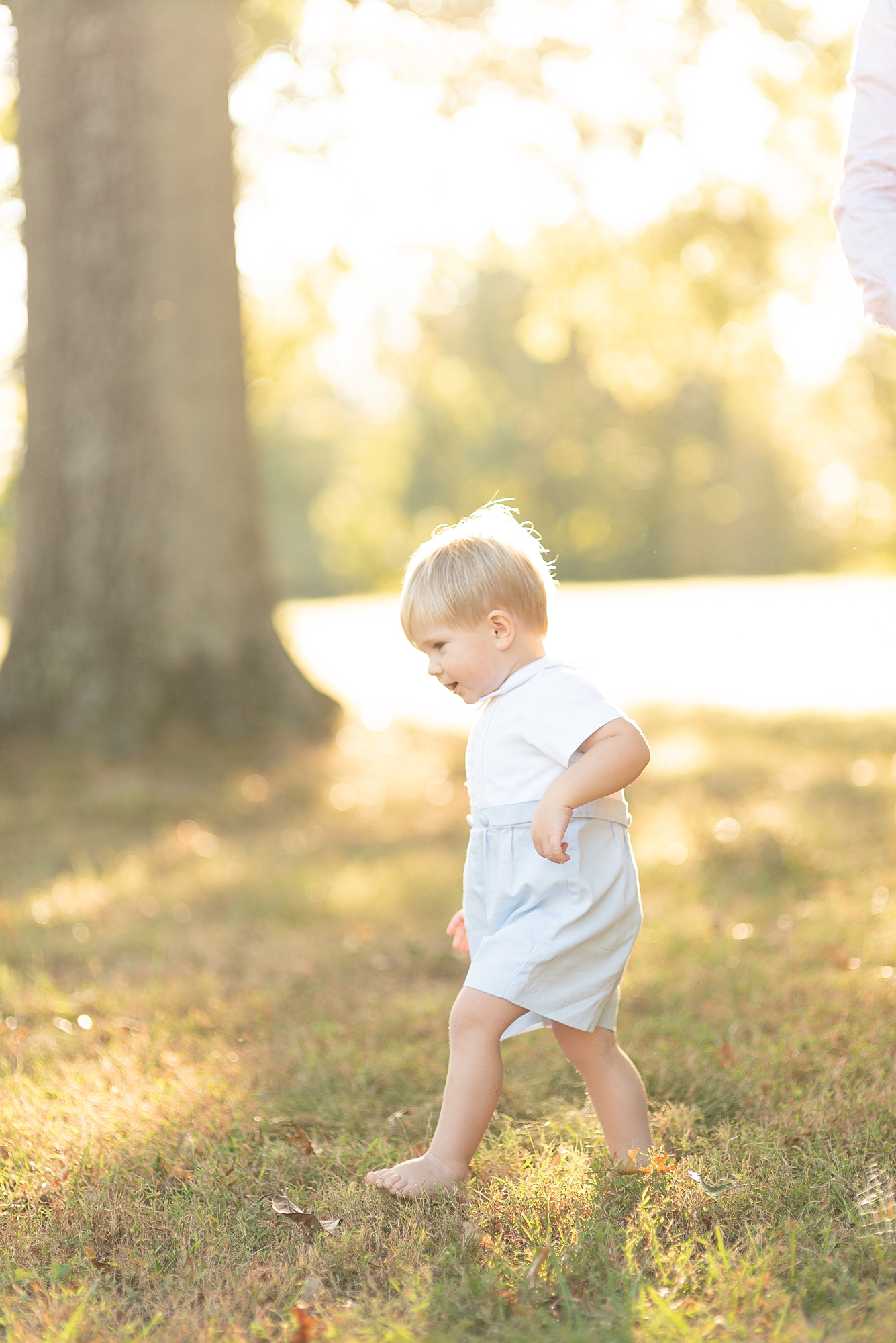 Toddler running through a nature center in Nashville TN for family portraits