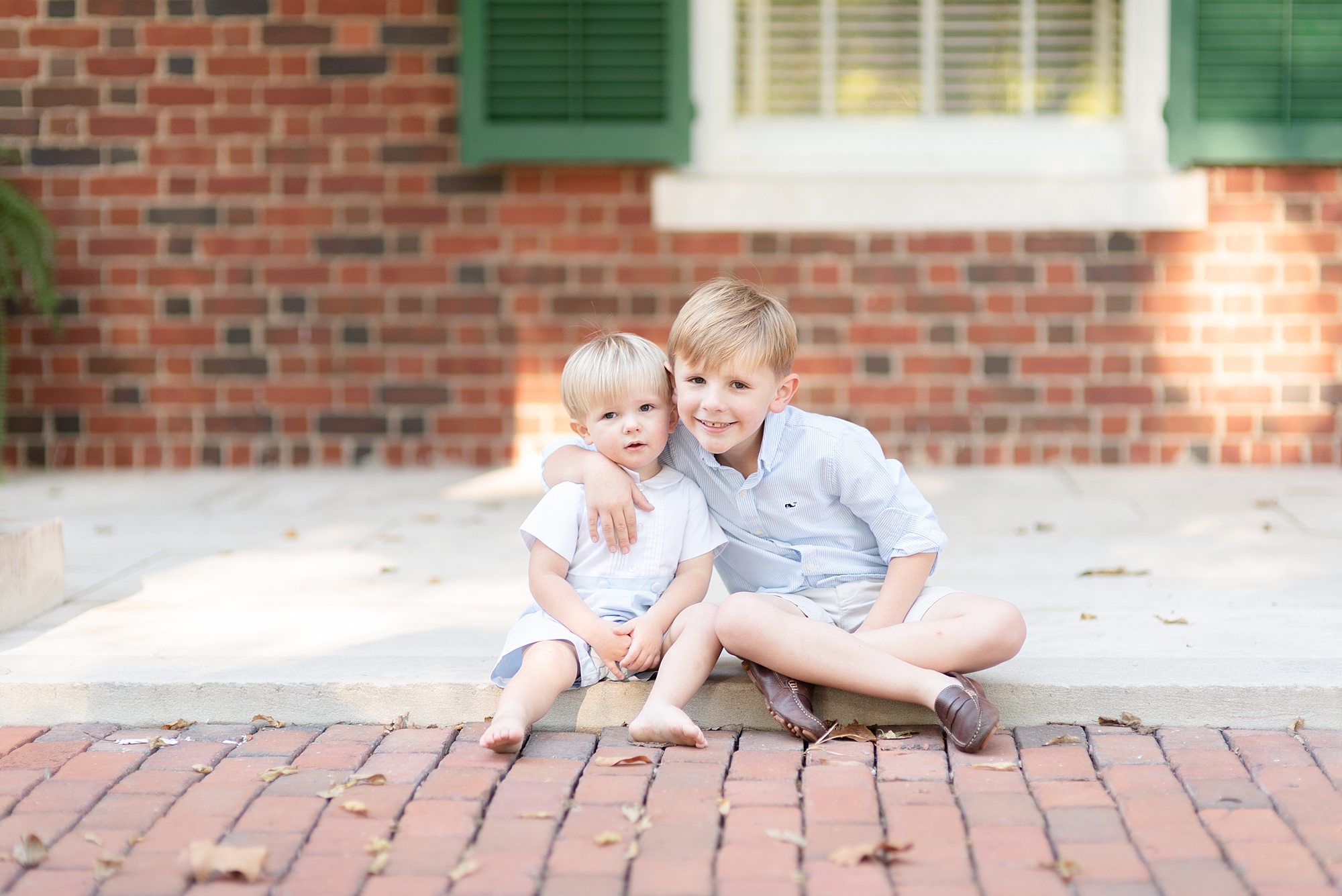 two brothers holding hands for family portraits in Nashville TN by Dolly DeLong Photography