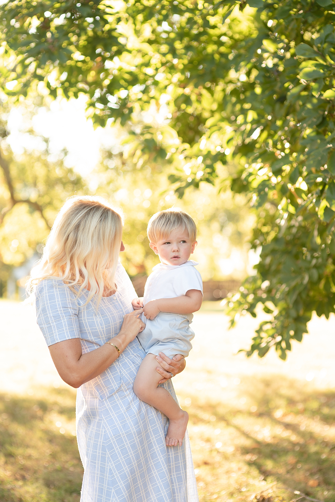 Mom holding her toddler son for family portraits at the Nashville Ellington Agricultural Center