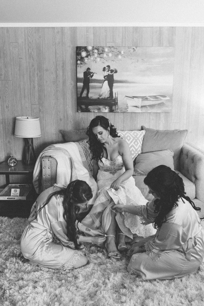 A black and white photo of bride and bridesmaids getting ready in Nashville Tennessee by southern wedding photographer Dolly DeLong Photography