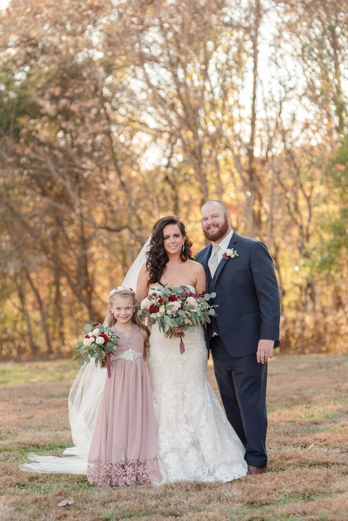 Bride with her daughter and husband on wedding day for family portraits