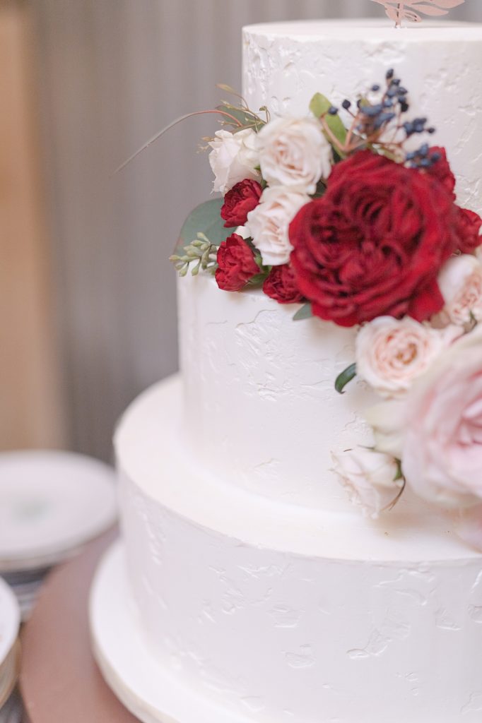 close up detail shot of a cake with red flowers