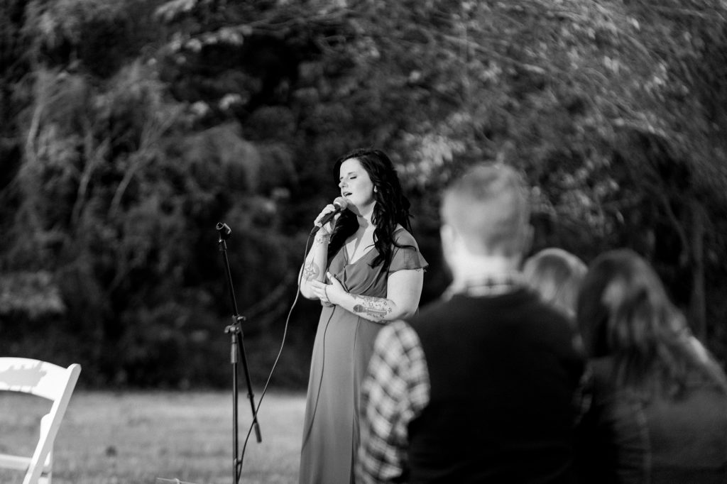 a black and white portrait of a woman singing for a wedding in the south