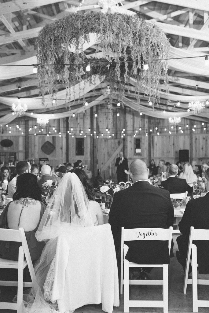 A black and white photo of a wedding reception featuring southern charming details of a farm wedding in Nashville