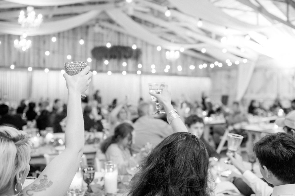 a black and white photo of a toast being given at a southern wedding