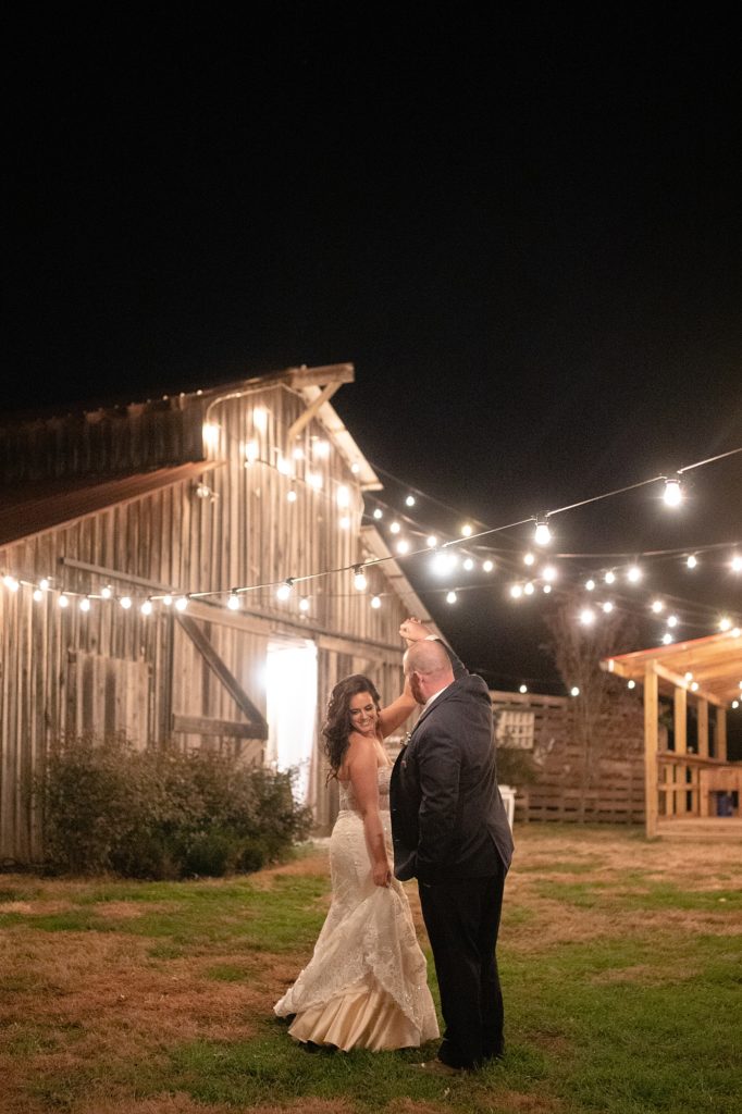 a bride and groom are dancing outside of a barn for their charming southern fall wedding in Nashville
