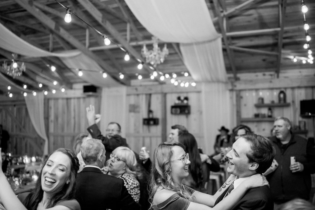 black and white portrait of people dancing at a wedding reception at hidden creek farm weddings