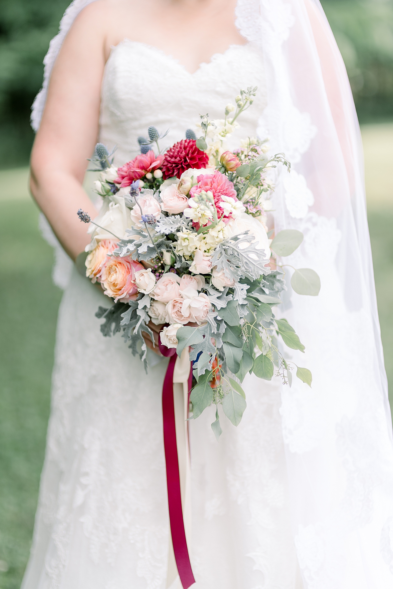 A Bride holding her wedding flowers for a Summer Wedding at Hidden Creek Farm Weddings