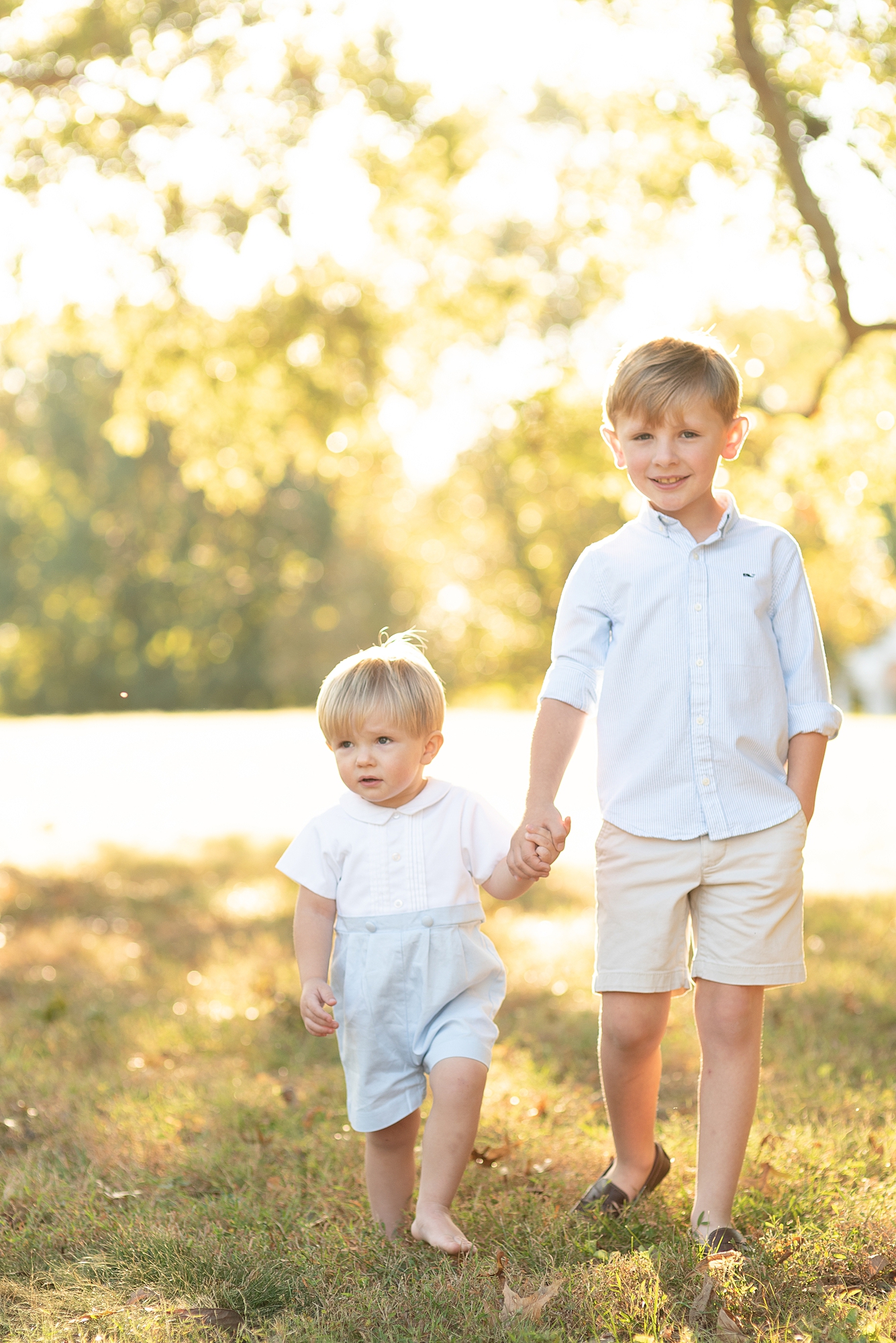 two brothers are walking towards the camera for their family portraits in Nashville