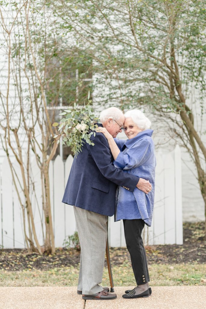 an older couple is holding hands and celebrating their lifelong love story at promise manor by Dolly DeLong Photography