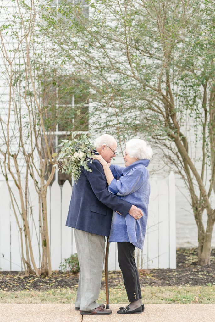 an older couple is holding hands and celebrating their lifelong love story at promise manor by Dolly DeLong Photography