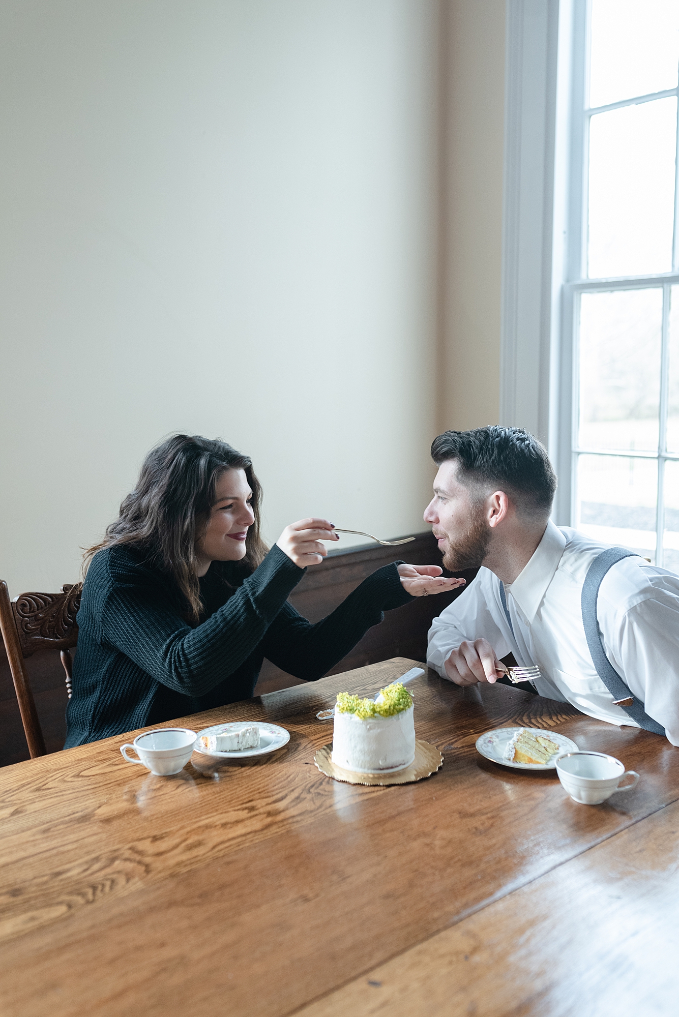 woman feeding her husband cake over a cup of coffee for a valentine's day date at promise manor