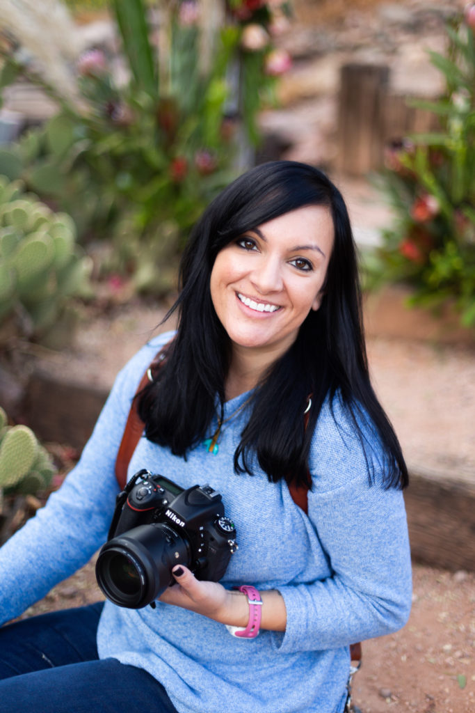 woman holding a camera sitting in phoenix, arizona for headshots destination photographer dolly delong photography