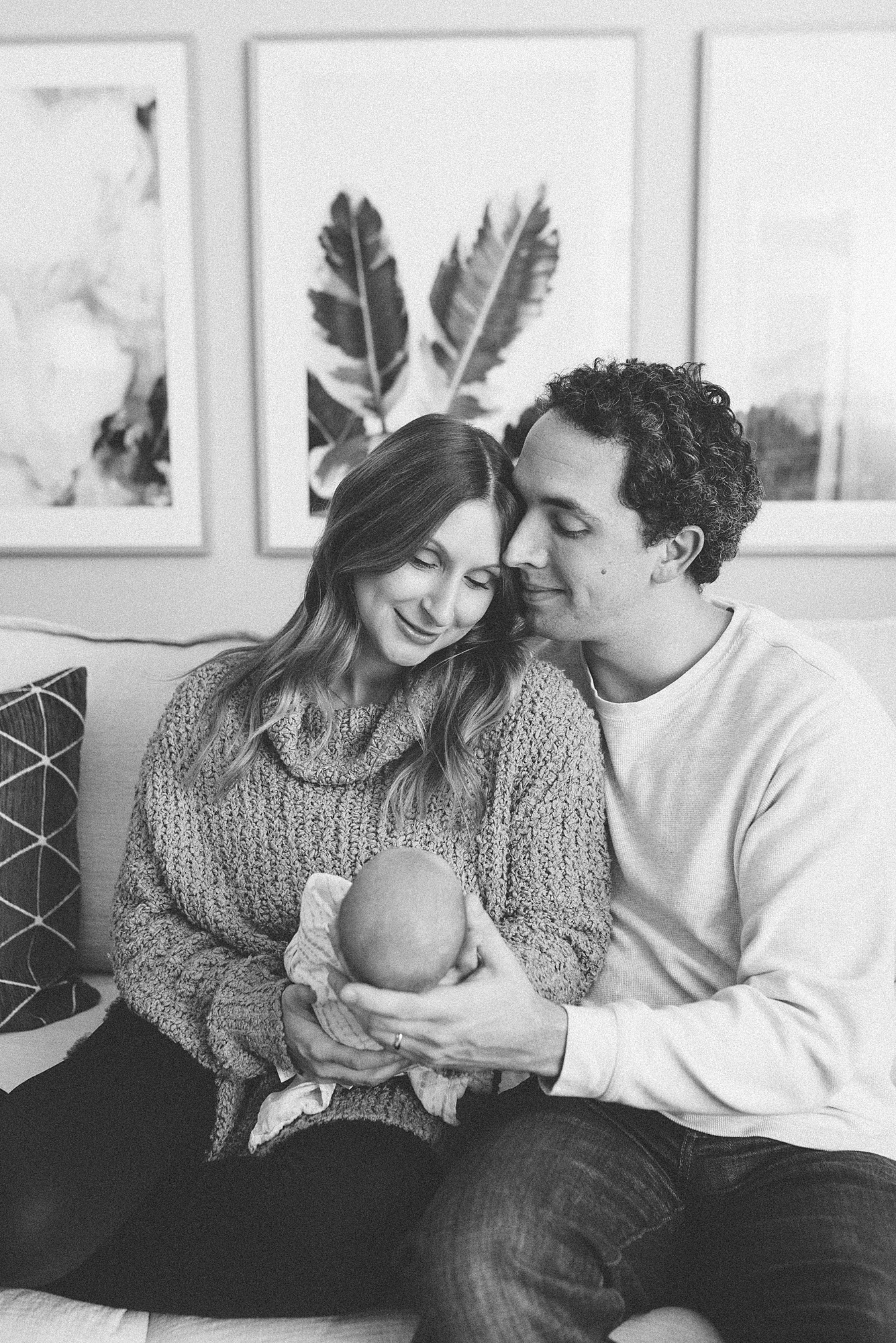 black and white portrait of a mom and dad holding their newborn baby girl in Nashville by Family Photographer Dolly DeLong Photography