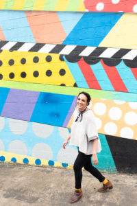 a nashville family photographer is walking along a colorful mural in downtown Nashville
