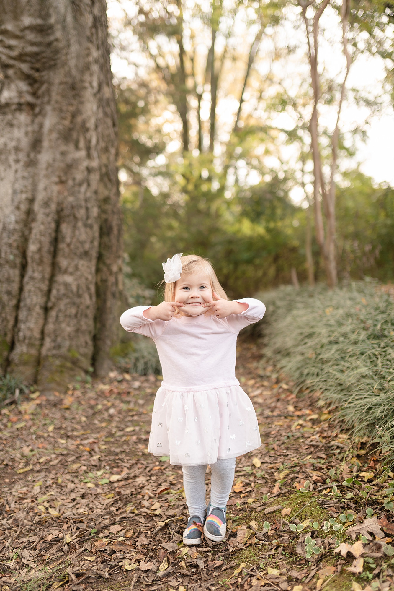 Little girl being silly in front of the camera at Historic Stone Hall in Nashville for family photography session by Dolly DeLong Photography