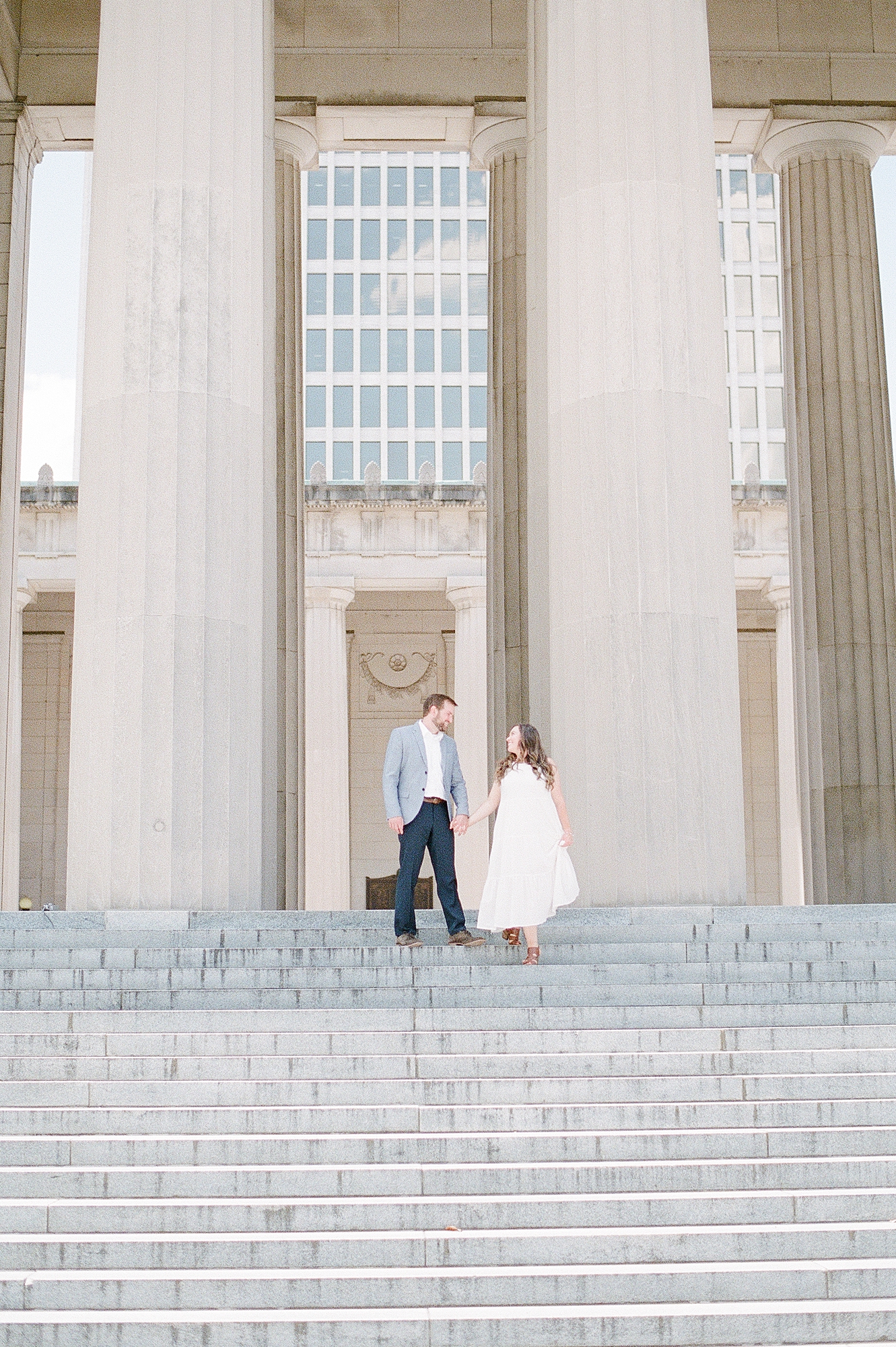 a husband and wife are celebrating their 4 year wedding anniversary with portraits on fuji400h film with Nashville engagement and family photographer Dolly DeLong Photographer at the War Memorial in Nashville