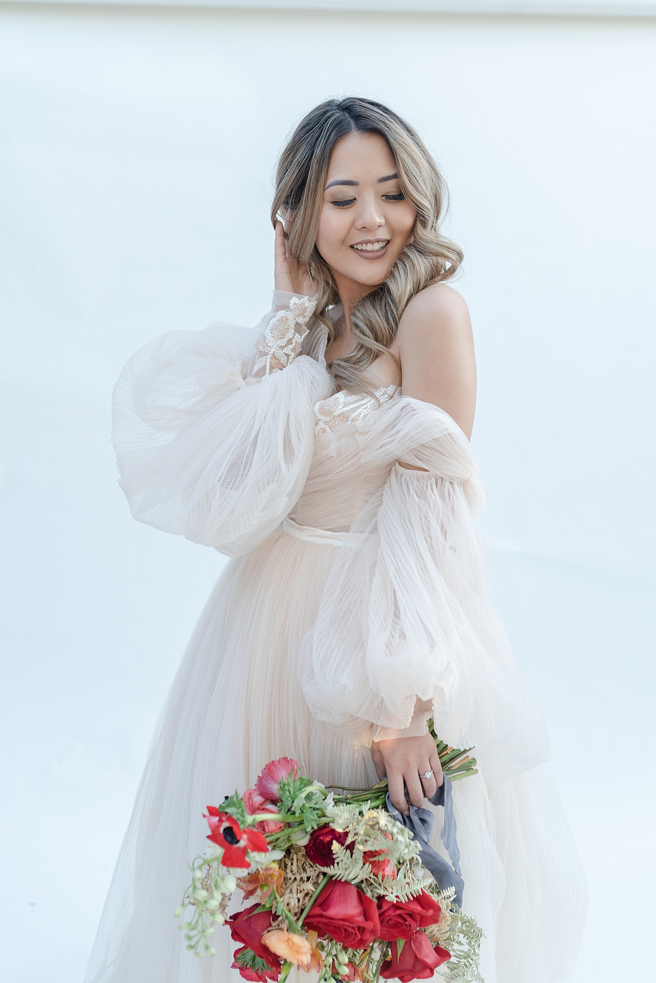 joyful asian bride right after her wedding is swinging her dress and smiling at the camera taken by Nashville elopement photographer Dolly DeLong Photography