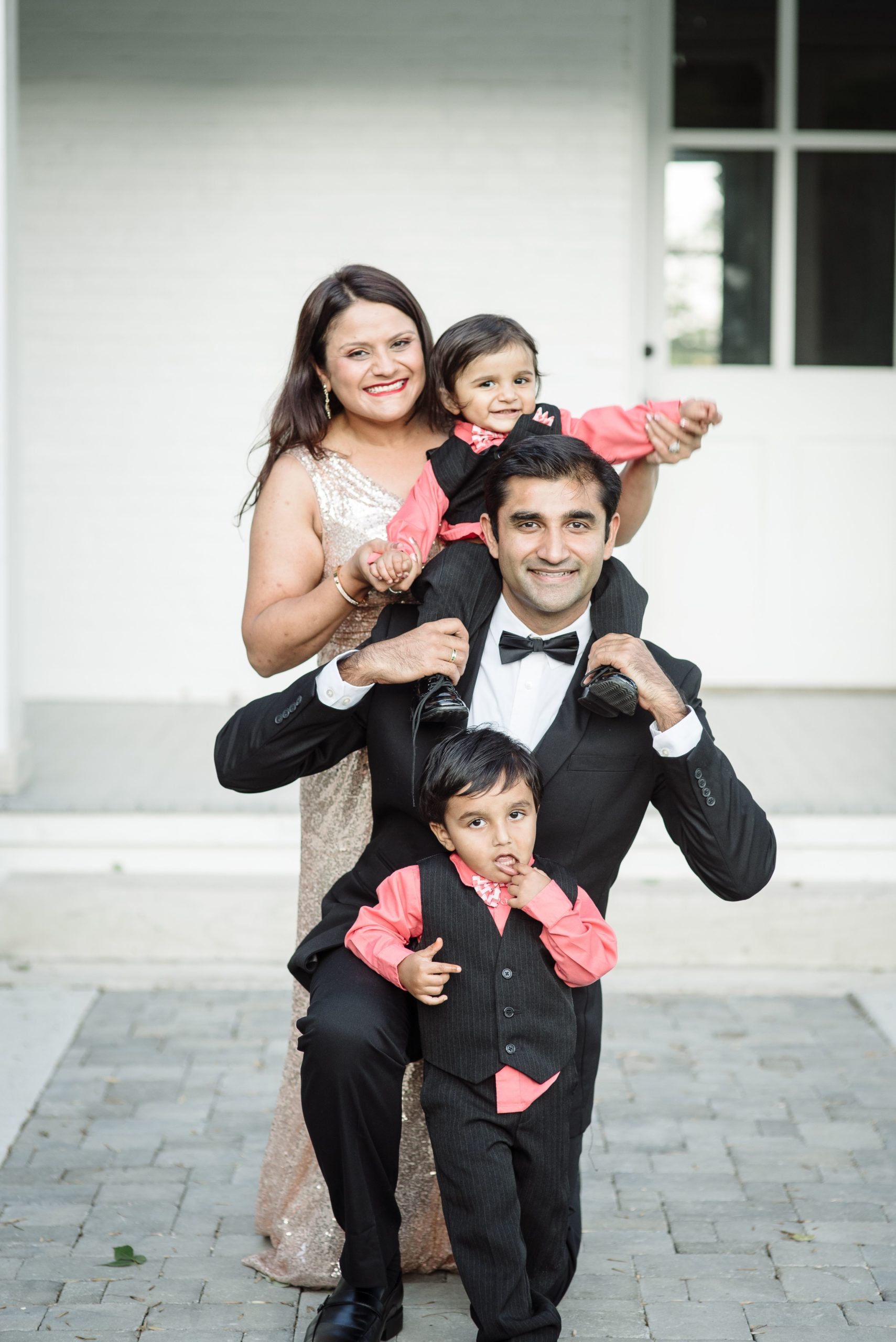 Indian family of four dressed in formal attire for family portraits at Ravenswood Mansion by Nashville Family Photographer Dolly DeLong Photography