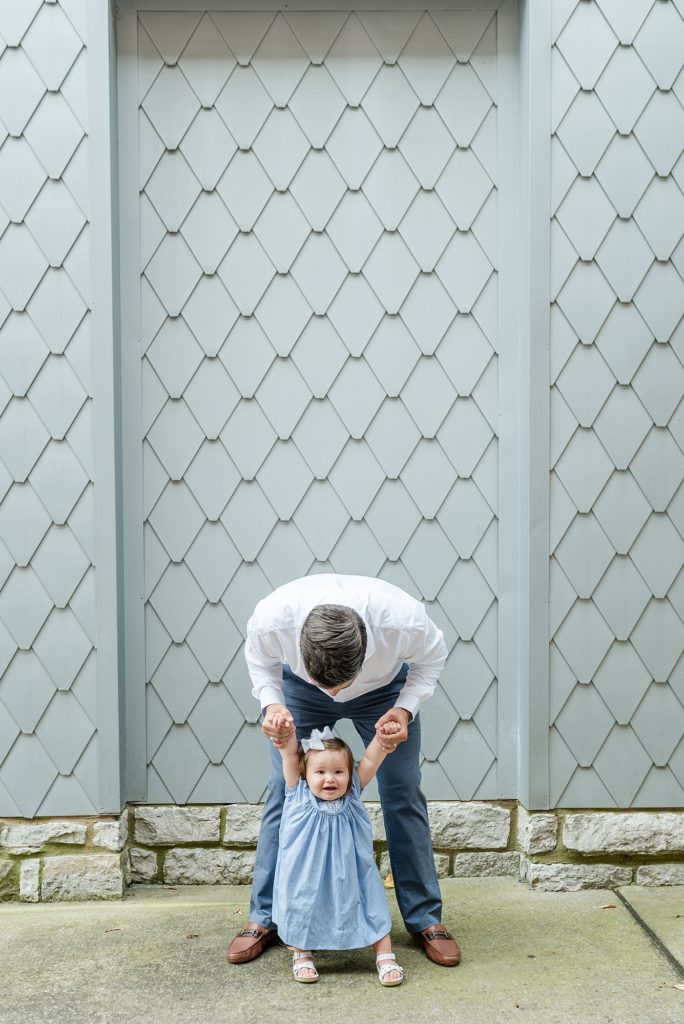 little girl and her daddy are playing and being silly in downtown franklin tennessee for family photos by nashville family photographer Dolly DeLong Photography