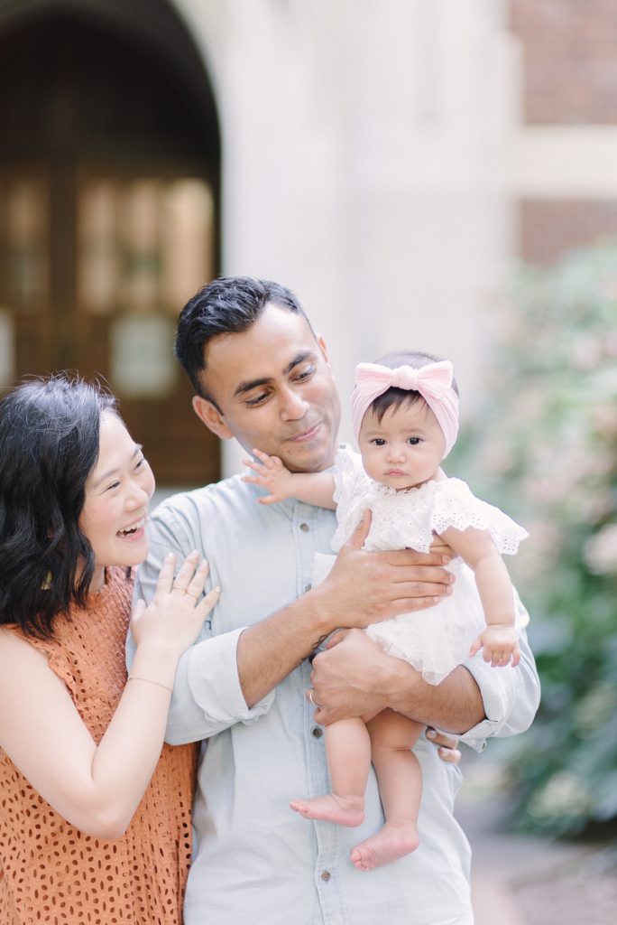 korean mom indian dad and their baby standing at Vanderbilt University for Family Photos with Nashville Family Photographer Dolly DeLong Photography