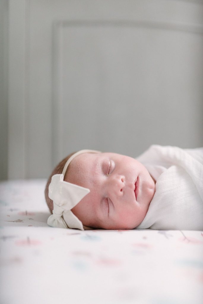 newborn details of a baby girl's headband while the baby sleeps by Nashville Newborn Photographer and Nashville Family Photographer Dolly DeLong Photography