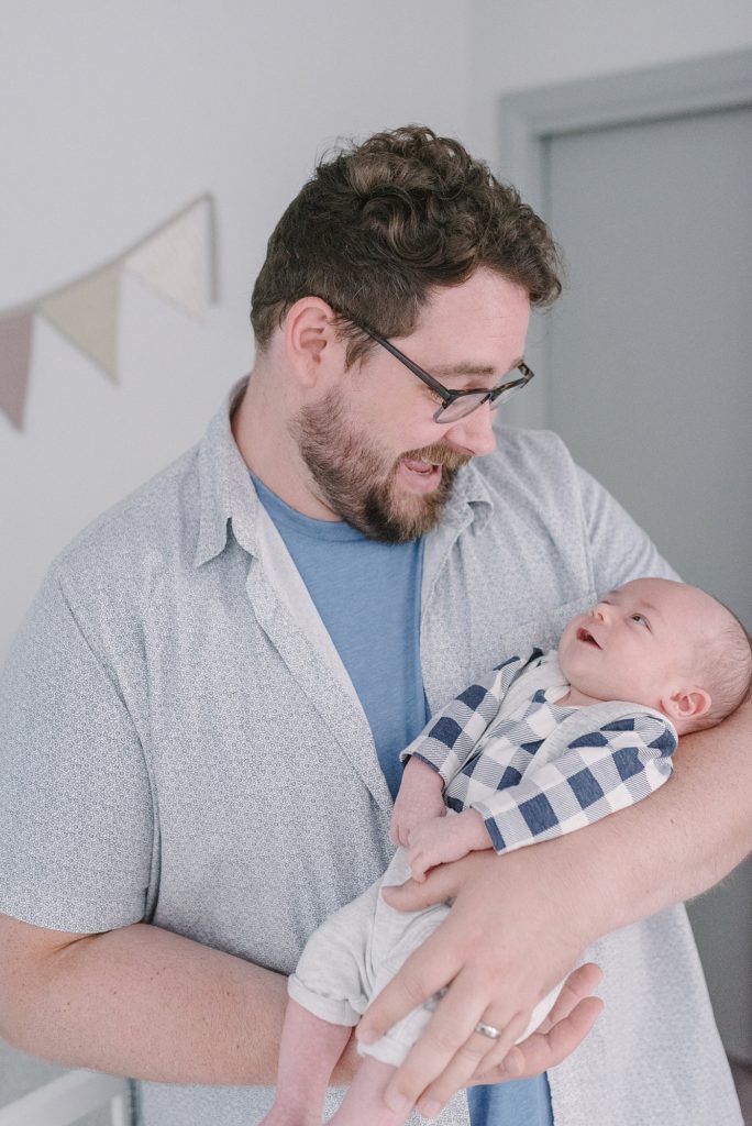 Daddy-holding-his-newborn-son-in-his-arms-and-sharing-a-classic-dad-joke