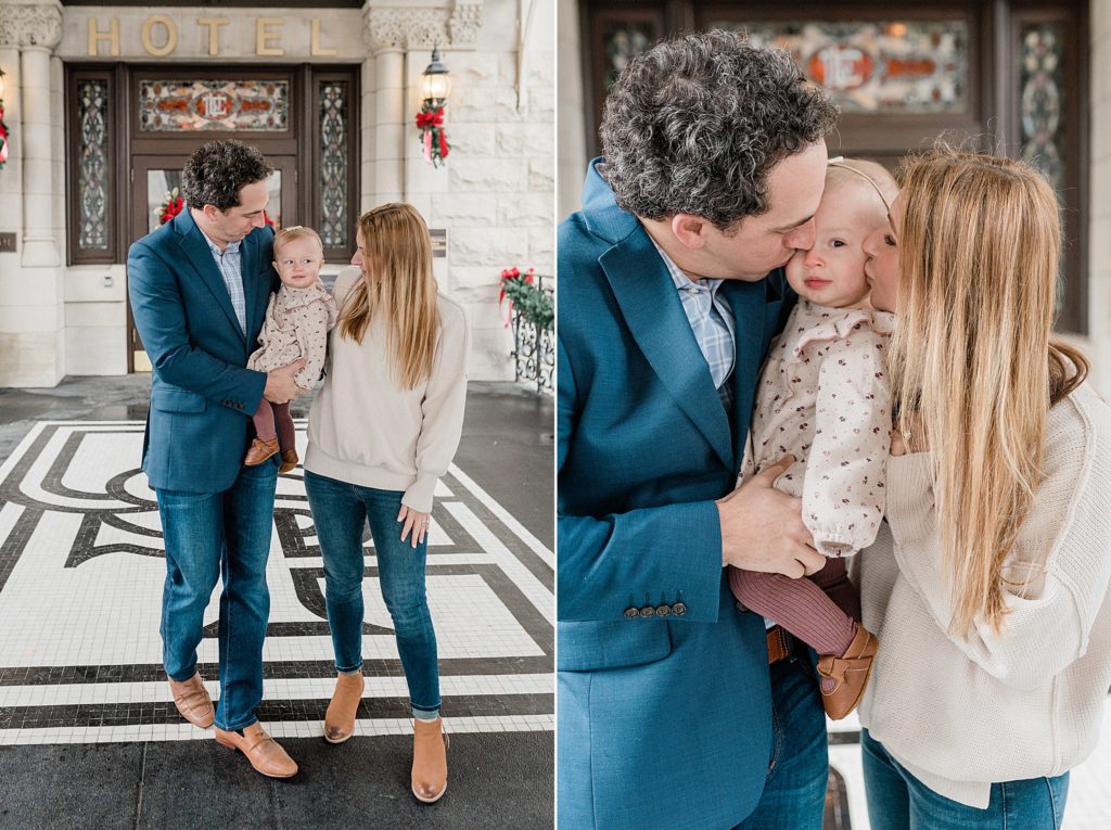 parents kiss one year old during winter family photos at Union Station Hotel