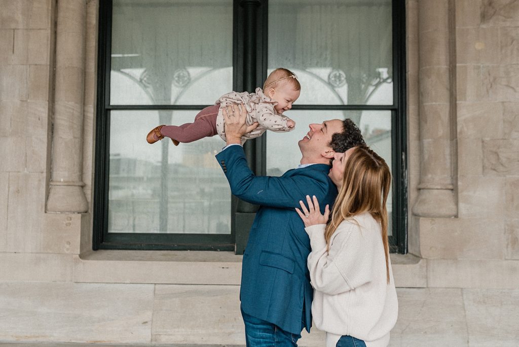 parents lift baby during first birthday portraits