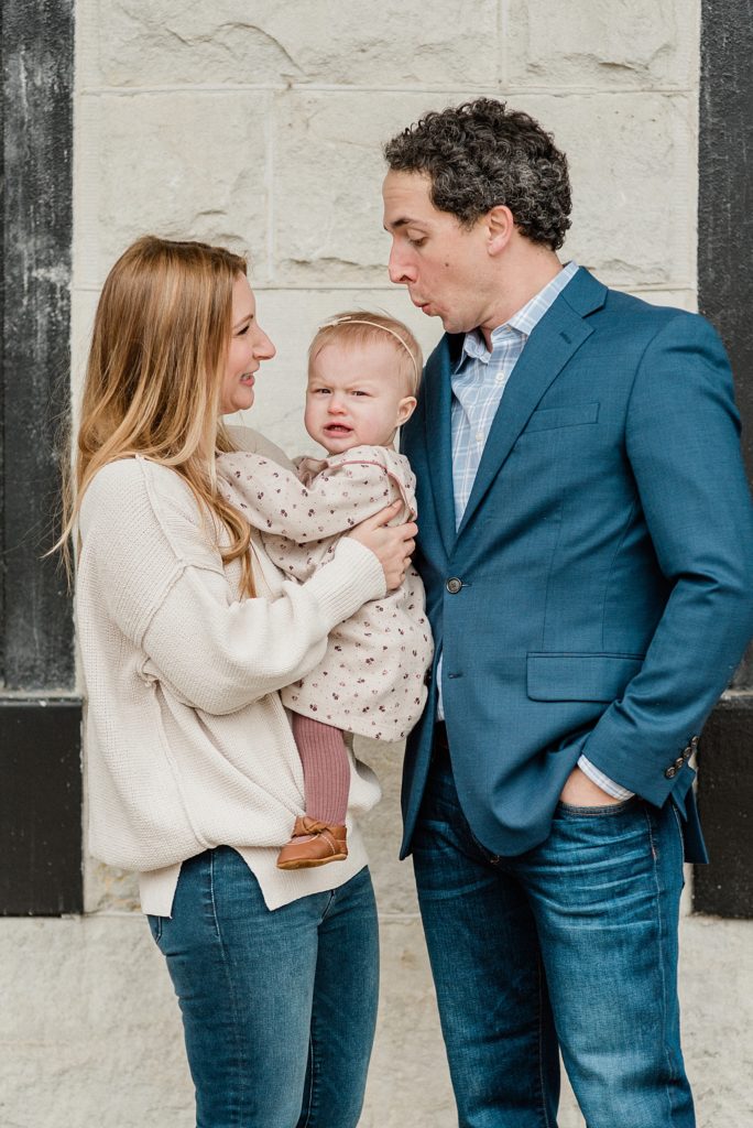 parents play with toddler during family portraits at Union Station Hotel
