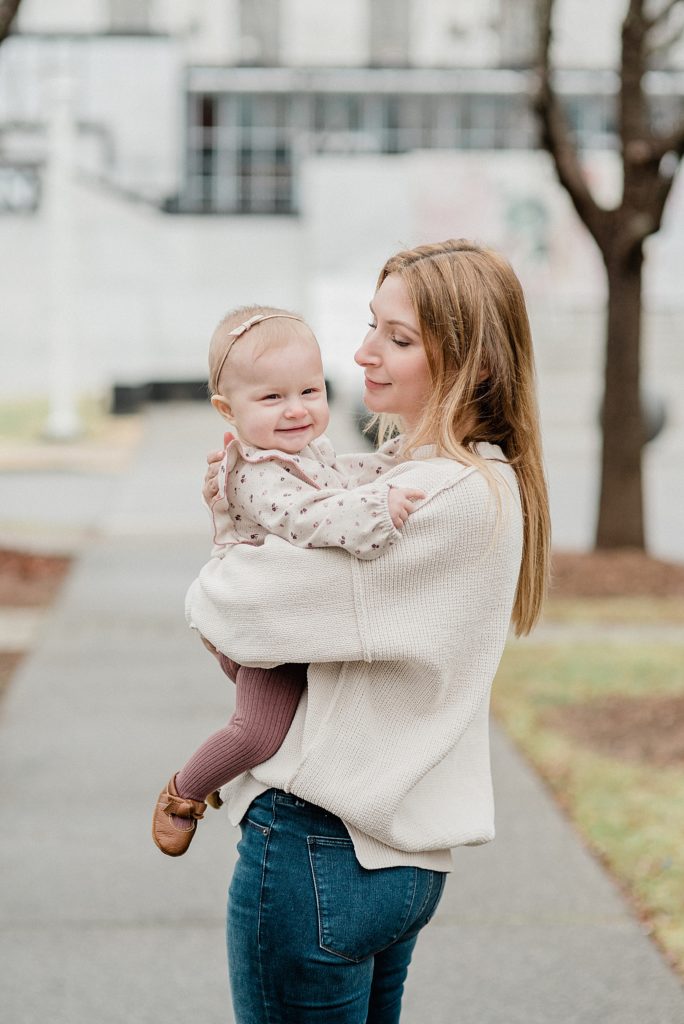 mom hugs toddler during family photos in Nashville TN