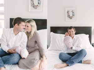 parents hold newborn baby girl on bed during lifestyle newborn session at home