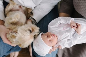 newborn baby girl licked by dog