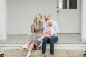 family of three poses on steps during Nashville personal branding portraits