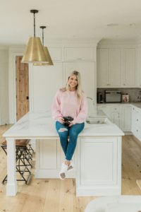 photographer rests on kitchen counter in Nashville