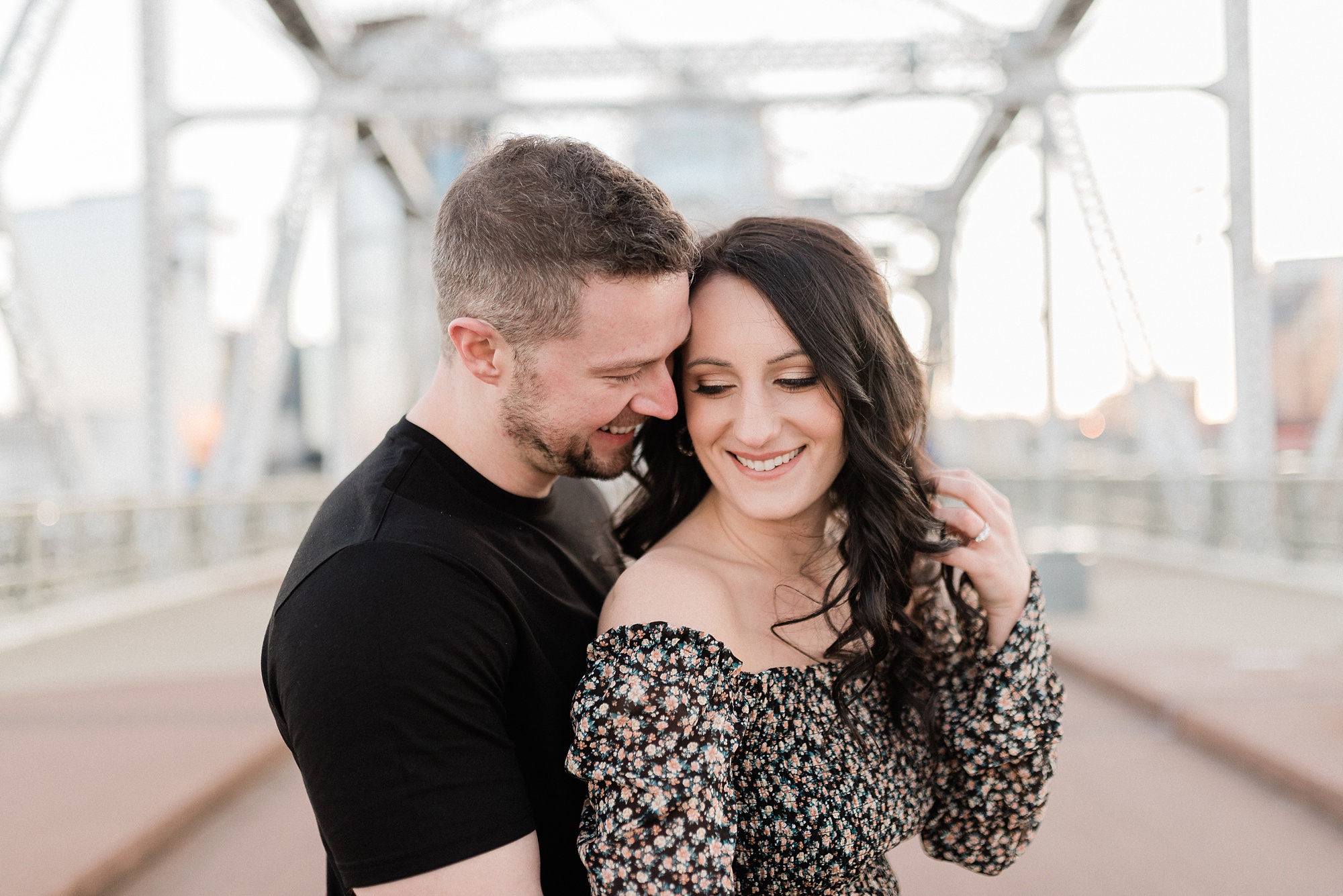 couple hugs on Pedestrian Bridge in Nashville TN