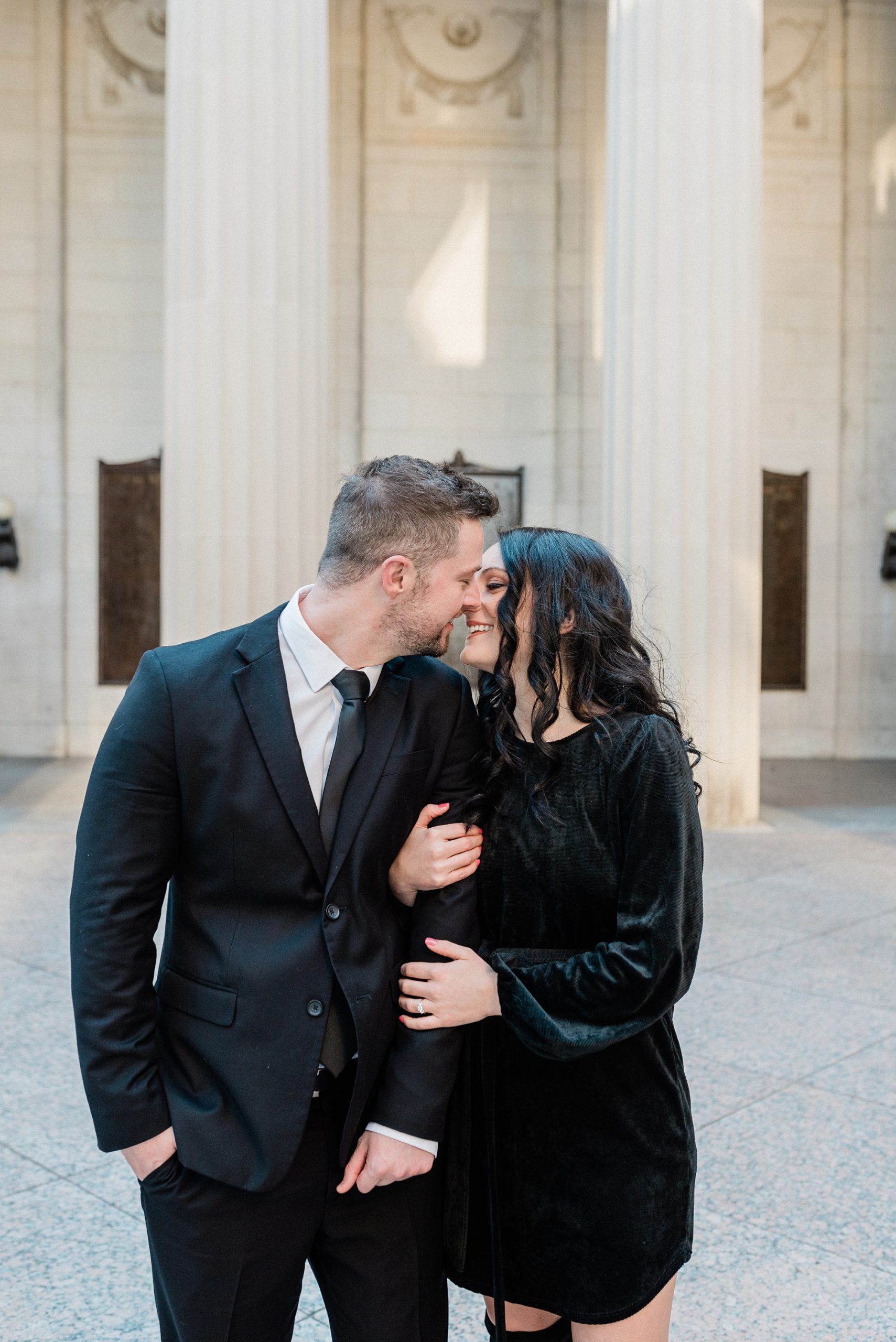 couple kisses in front of columns of War Memorial