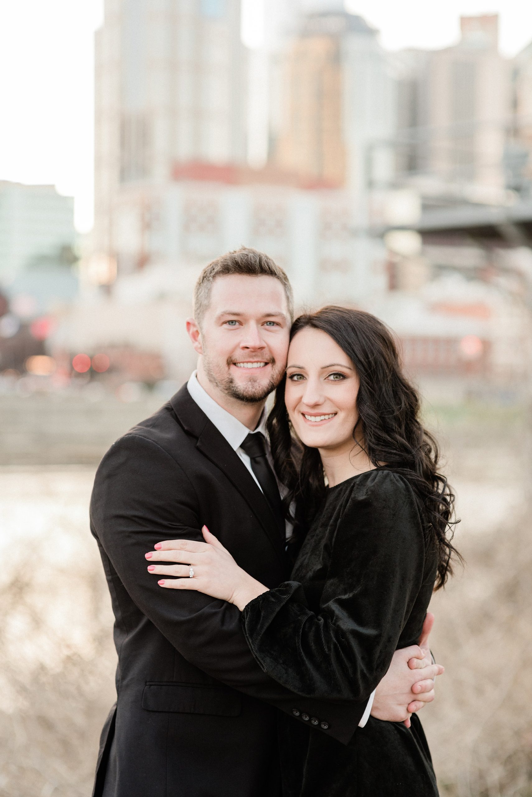 couple poses by downtown Nashville skyline