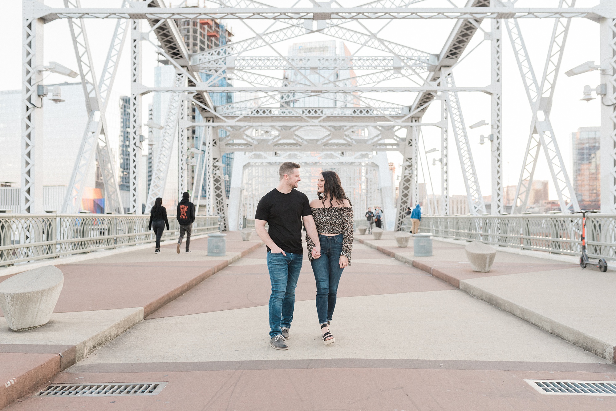 couple walks over the Pedestrian Bridge in Nashville
