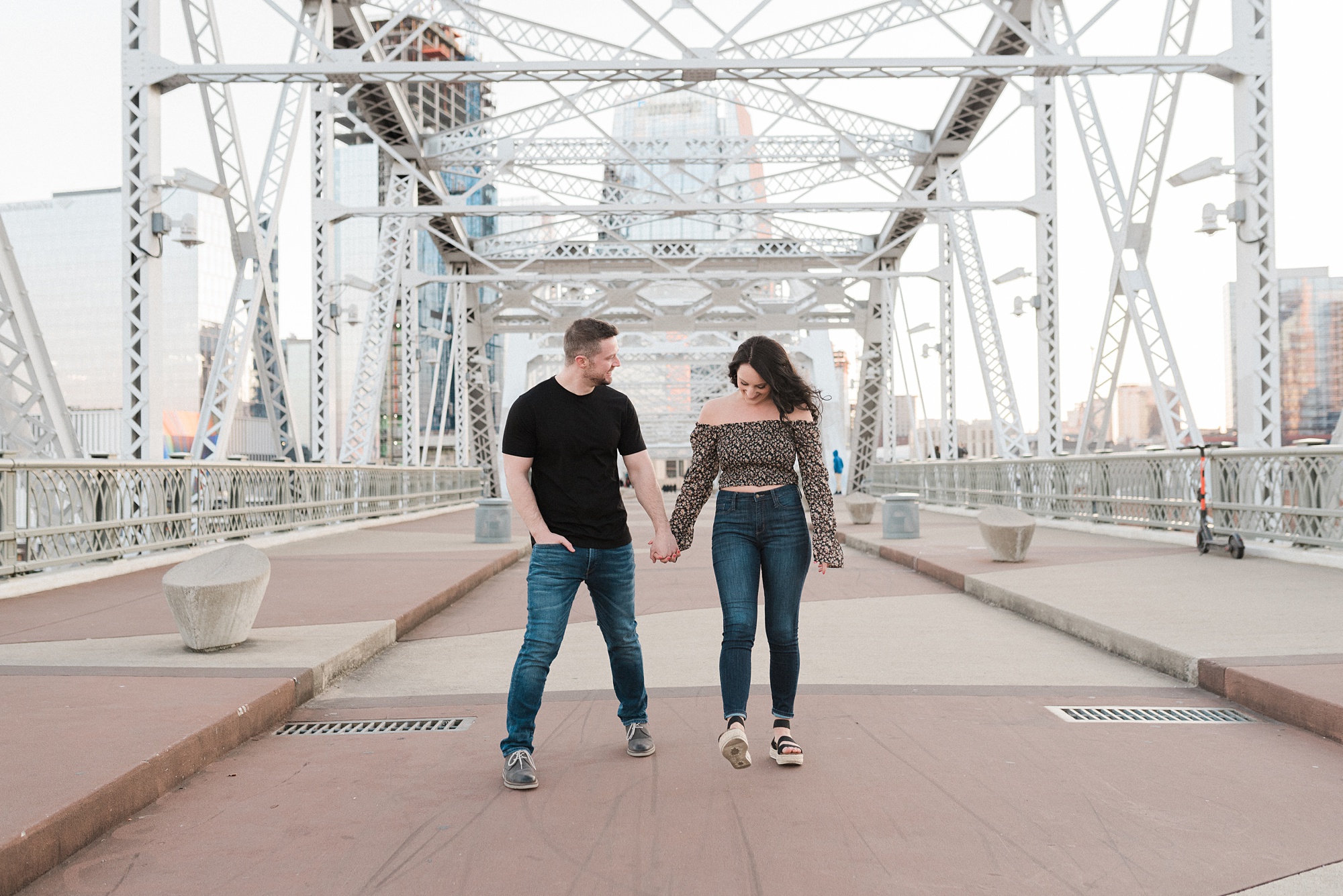 couple laughs during downtown Nashville engagement session