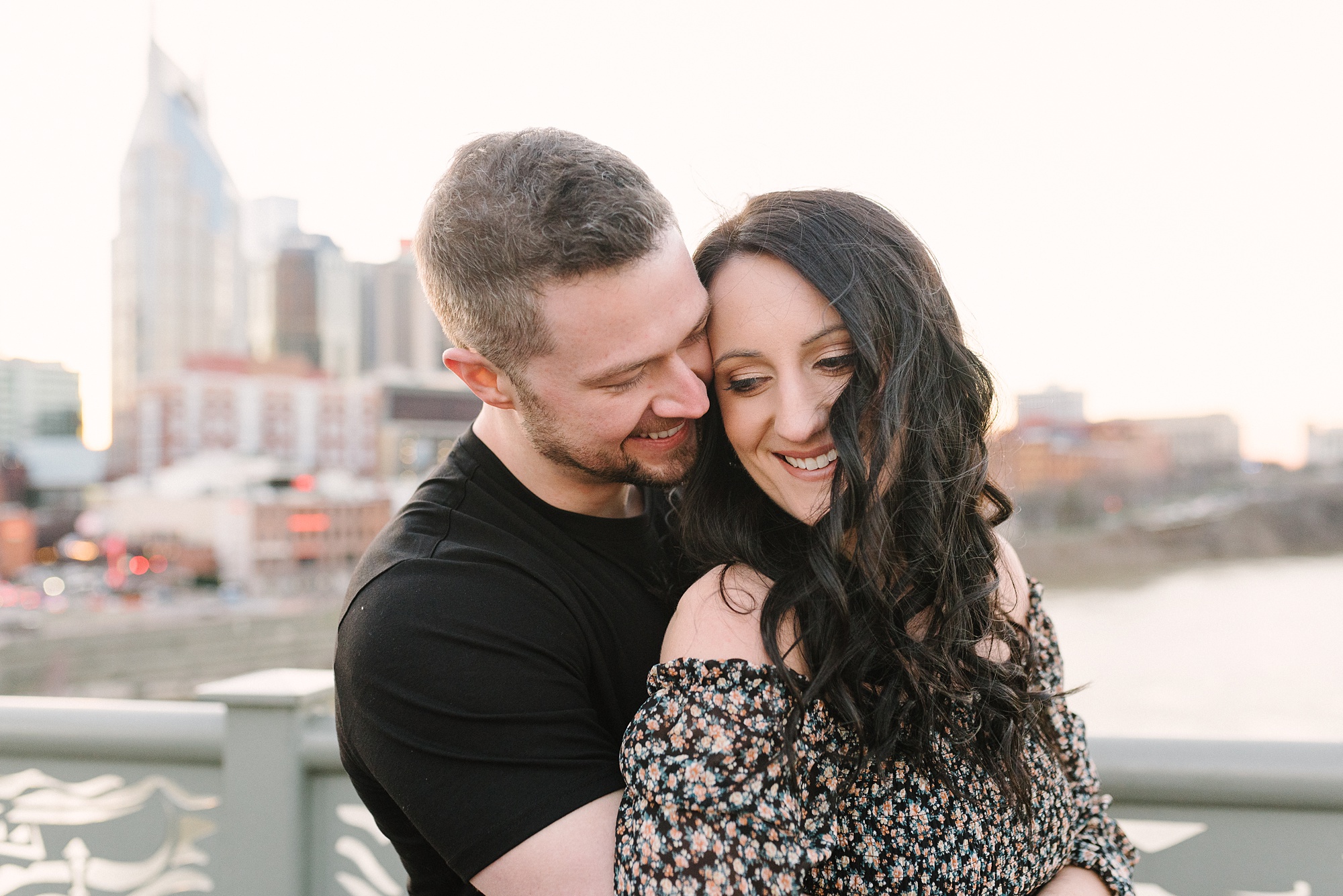 groom nuzzles bride's cheek during downtown Nashville engagement session