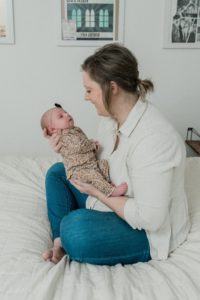 mom looks at baby girl during Franklin TN newborn portraits at home